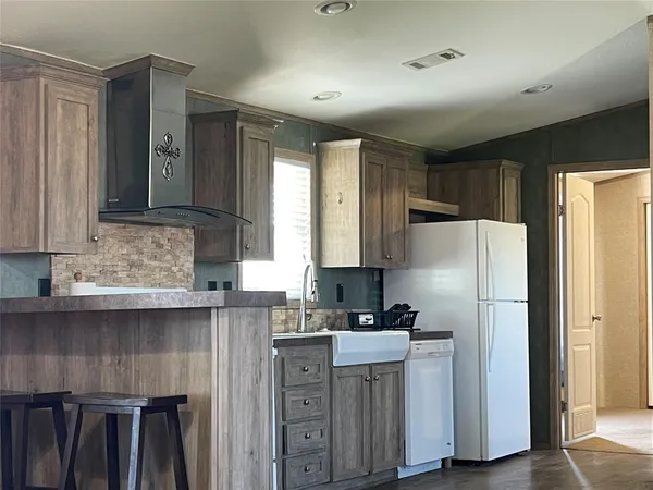 a kitchen with stainless steel appliances granite countertop a refrigerator sink and cabinets