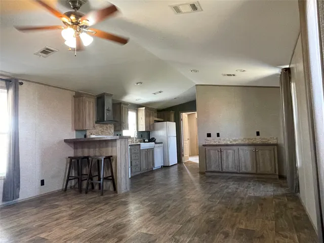a large kitchen with a table and chairs
