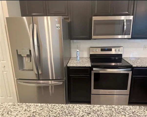 a kitchen with a stove microwave and refrigerator