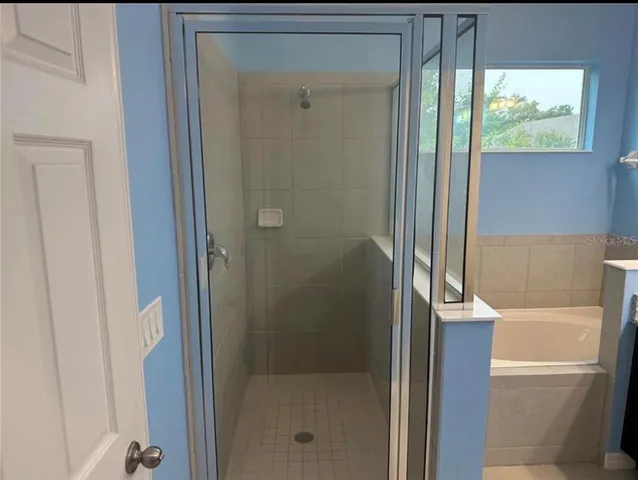 a bathroom with a bathtub and a shower