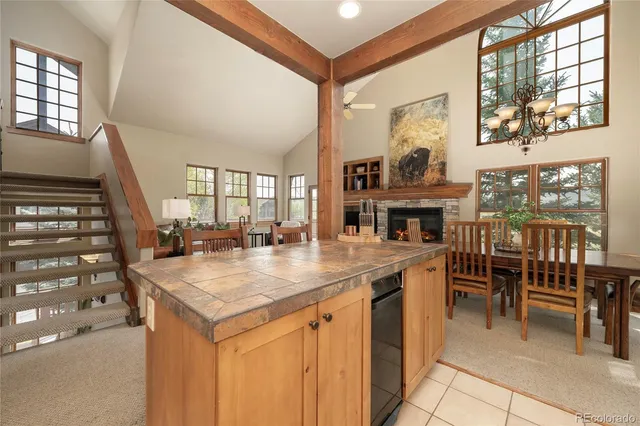 a view of a dining room with furniture and chandelier