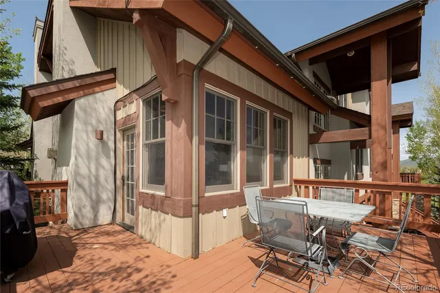 a view of wooden deck and a yard with swimming pool