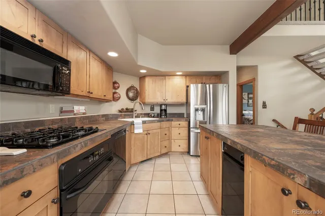 a view of kitchen island with granite countertop window and chairs