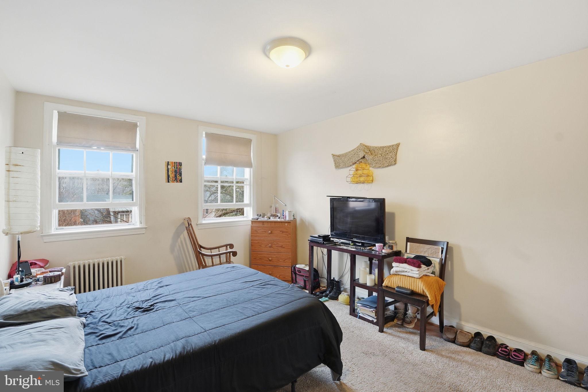 2712 Ordway Street Northwest, Unit 4 Washington, DC 20008 - Photo 12 of 16 a bedroom with a bed and wooden floor