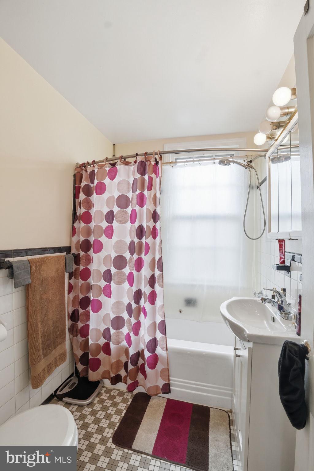 2712 Ordway Street Northwest, Unit 4 Washington, DC 20008 - Photo 15 of 16 a bathroom with a sink and a mirror