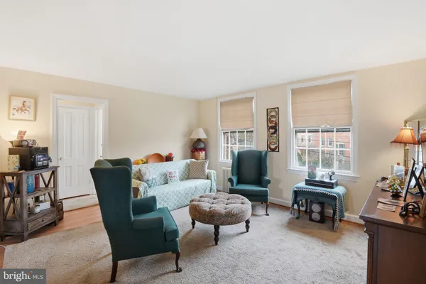 a living room with furniture and a flat screen tv with wooden floor