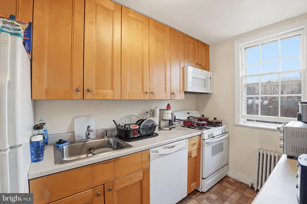 a kitchen with a sink cabinets and window