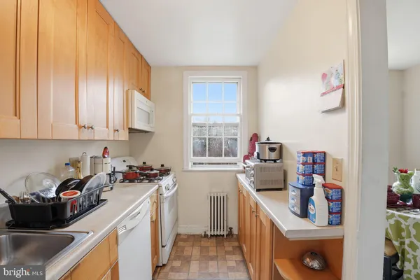 a kitchen with sink a stove and cabinets