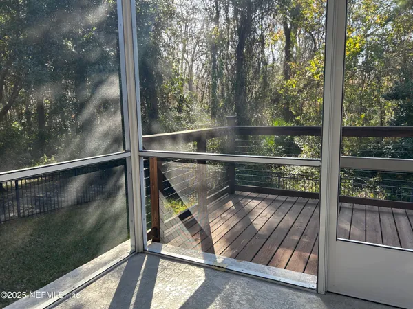 a view of a balcony with wooden floor