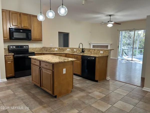 a kitchen with stainless steel appliances granite countertop a stove and a sink