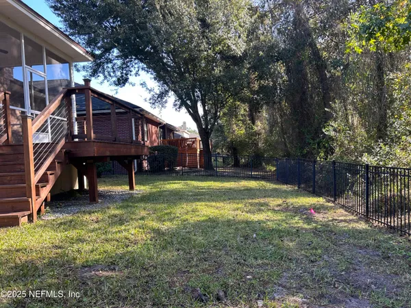 a backyard of a house with table and chairs