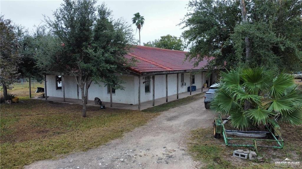 5906 North Brushline Road Mission, TX 78574 - Photo 13 of 29 a house with a tree in the yard