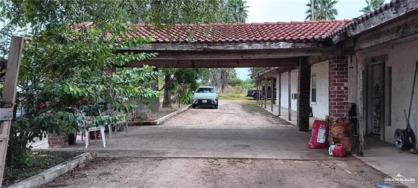 a view of a wooden house with a large tree
