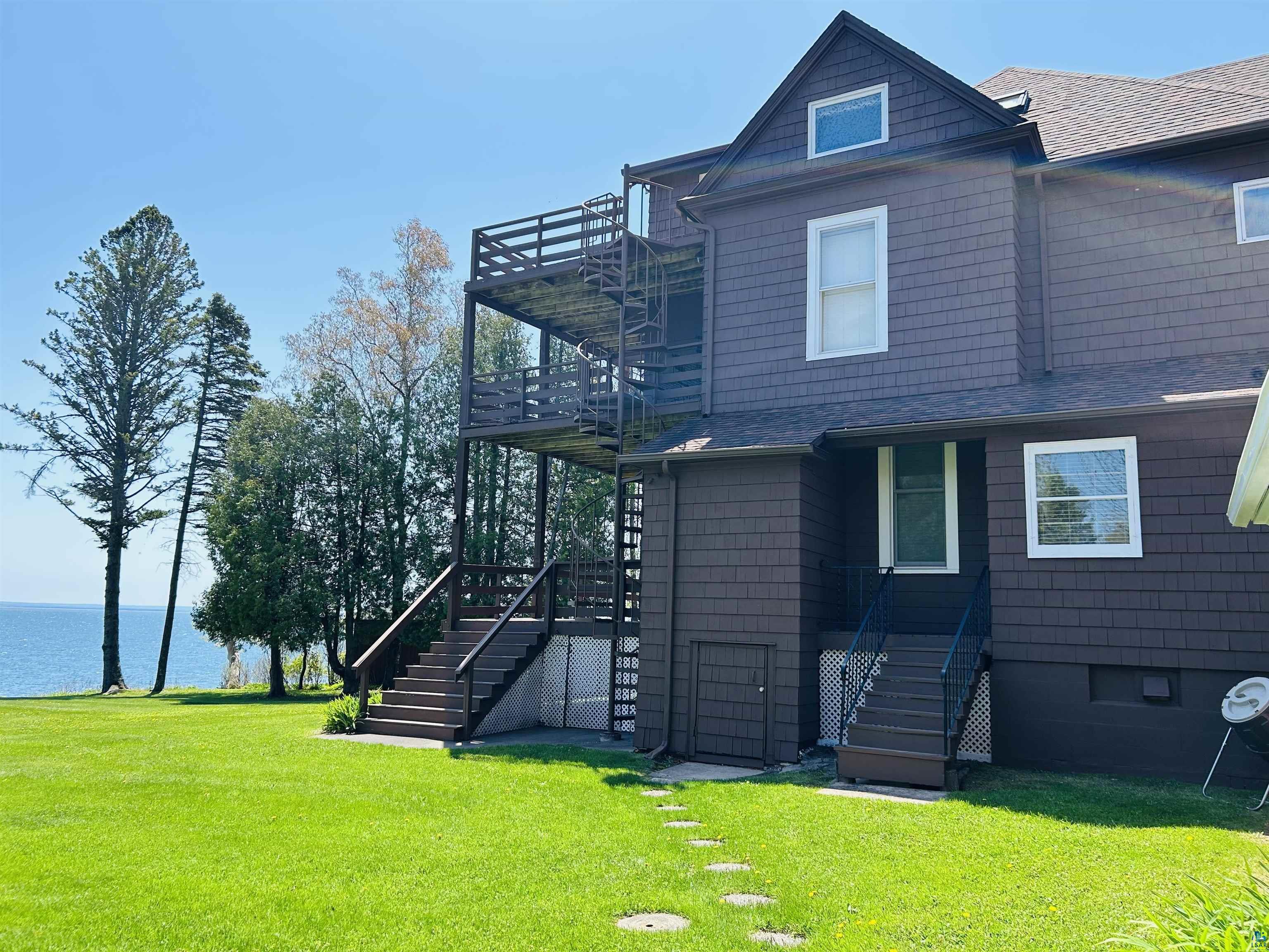5090 London Road, Unit 1 Duluth, MN 55804 - Photo 31 of 54 Two-story exterior with shake siding and a multi-level deck system