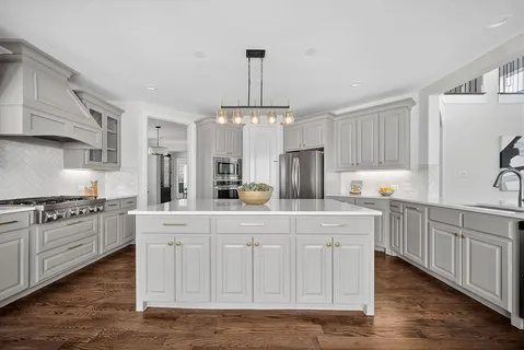 a kitchen with white cabinets and white appliances