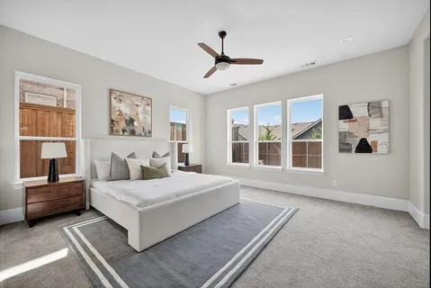 a bedroom with a large bed and a window