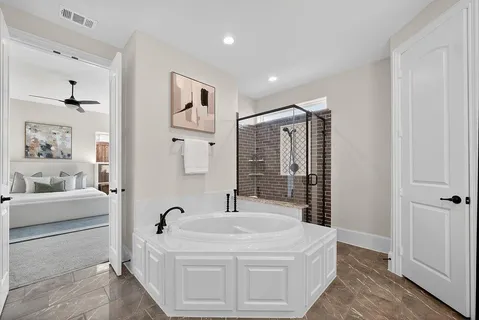 a bathroom with a bathtub sink and mirror
