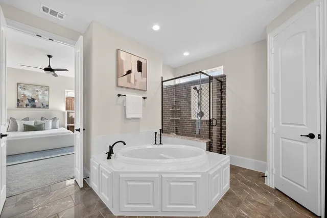 a bathroom with a bathtub sink and mirror