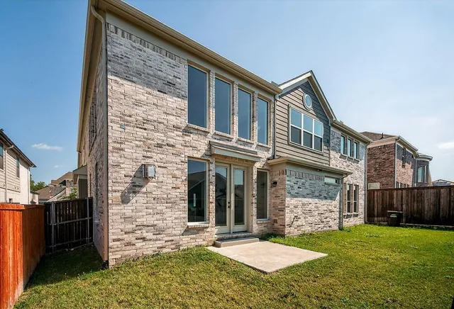 a view of a backyard with a garden and entertaining space