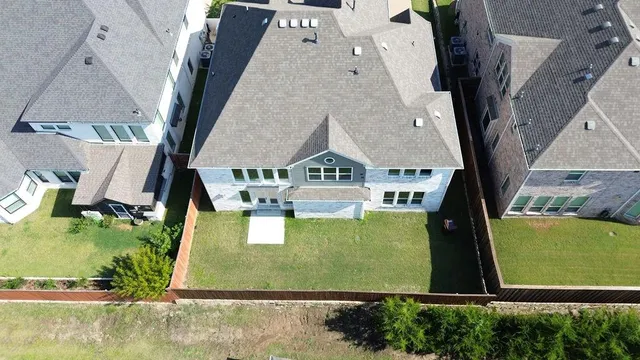 an aerial view of a house with a yard and pool