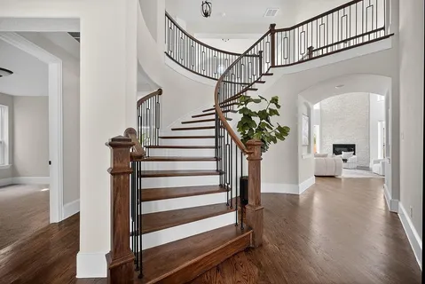 a view of entryway and hall with wooden floor