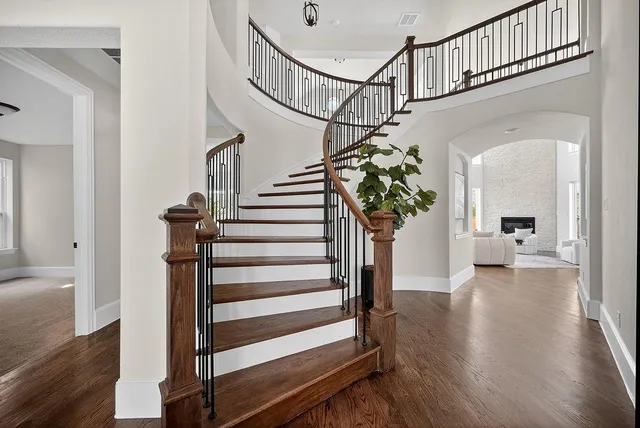 a view of entryway and hall with wooden floor