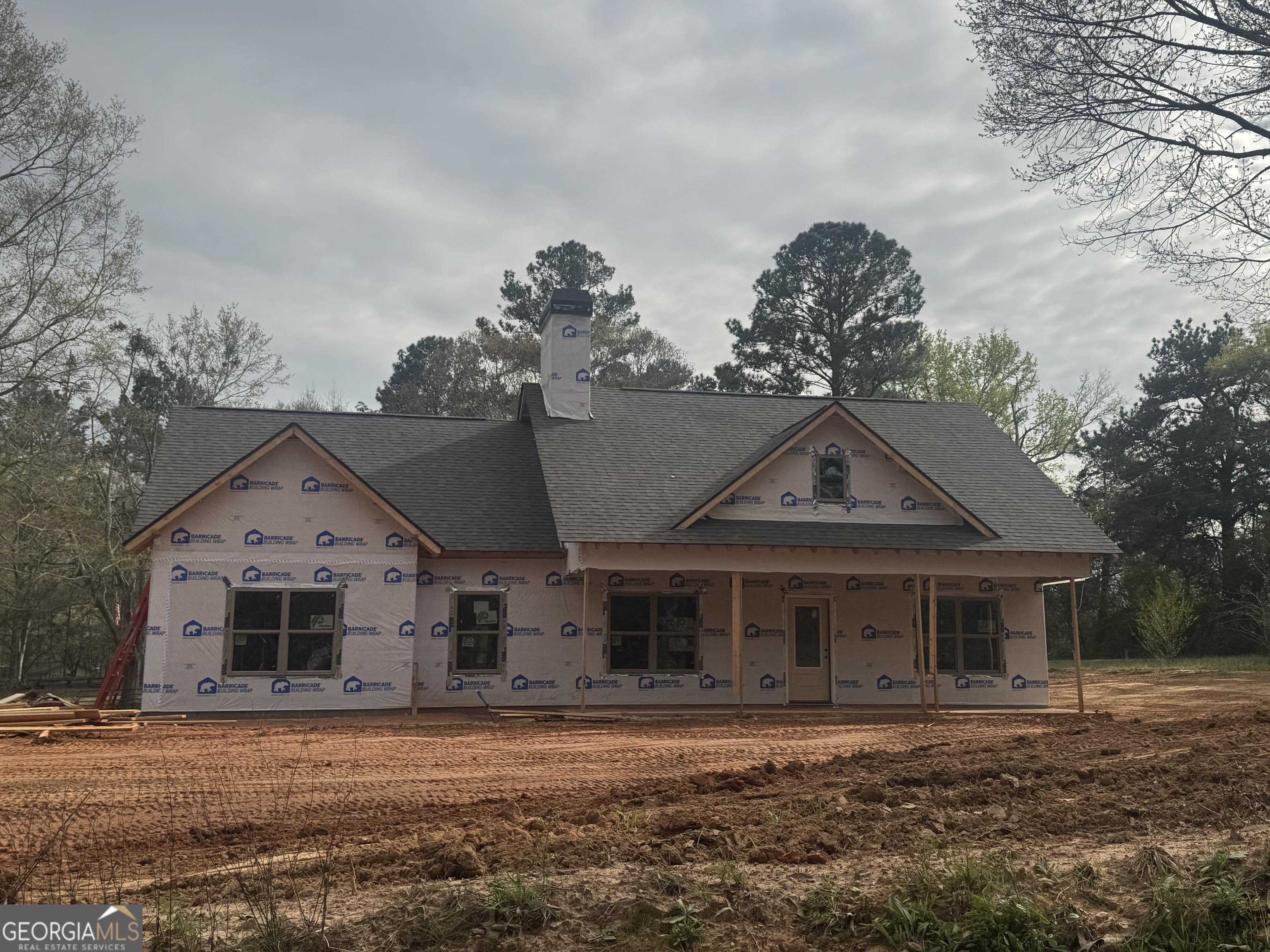 206 McKneely Road Milner, GA 30257 - Photo 2 of 2 a front view of a house with a garden