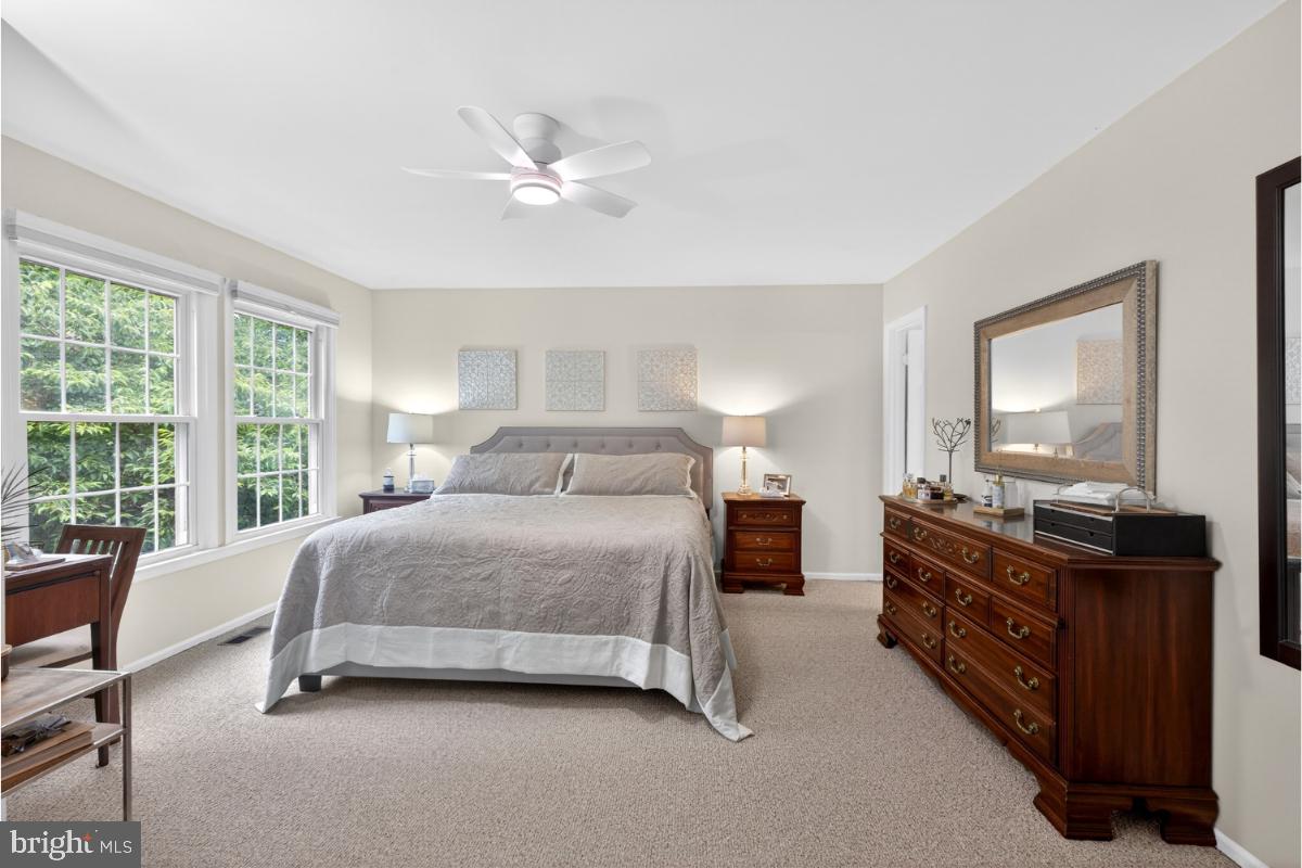 7347 Swan Point Way, Unit 122 Columbia, MD 21045 - Photo 20 of 54 a bedroom with a bed and dresser with mirror