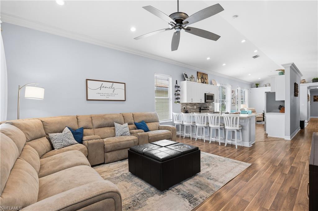 1770 Ribbon Fan Lane Naples, FL 34119 - Photo 16 of 37 a living room with furniture and a view of kitchen