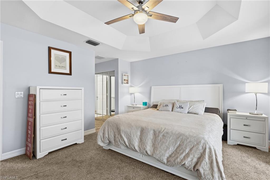 1770 Ribbon Fan Lane Naples, FL 34119 - Photo 18 of 37 a bedroom with a bed and a ceiling fan
