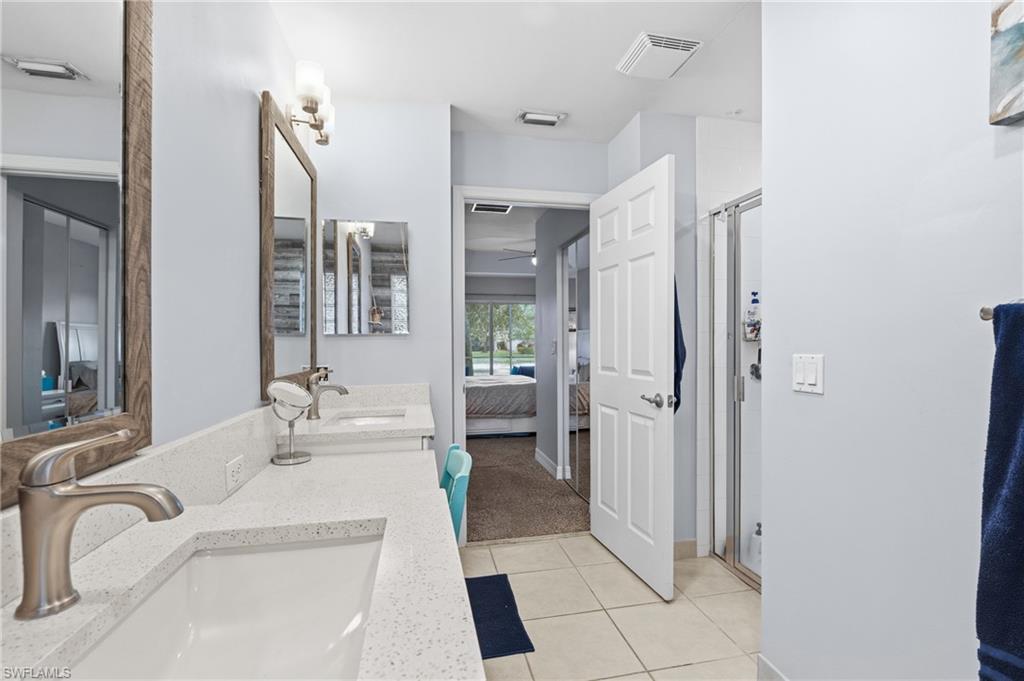 1770 Ribbon Fan Lane Naples, FL 34119 - Photo 19 of 37 a bathroom with a tub sink and mirror