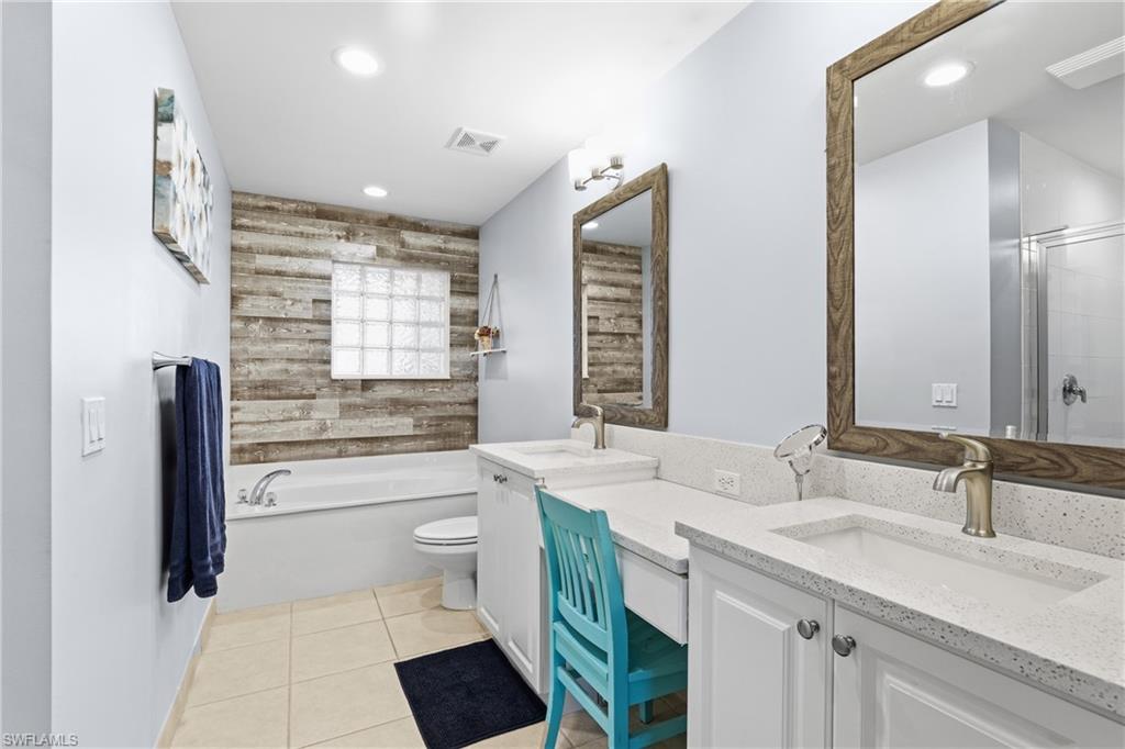 1770 Ribbon Fan Lane Naples, FL 34119 - Photo 20 of 37 a bathroom with a sink a toilet a mirror and shower