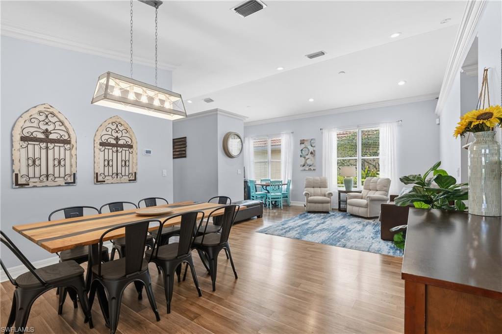 1770 Ribbon Fan Lane Naples, FL 34119 - Photo 9 of 37 a view of a dining room with furniture window and wooden floor