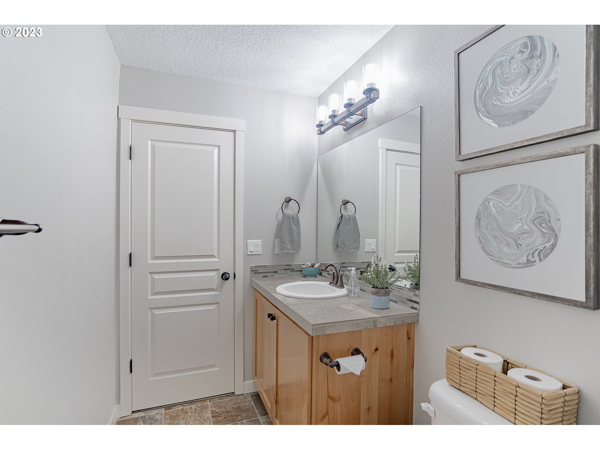 4020 North 1st Way Ridgefield, WA 98642 - Photo 20 of 32 a bathroom with a sink vanity and a mirror