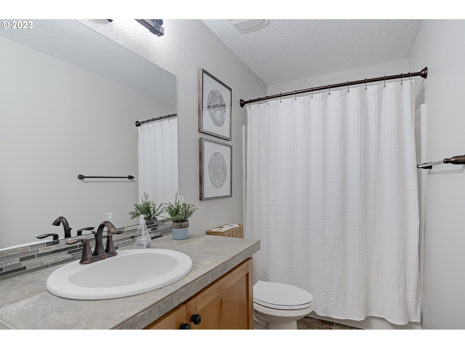 4020 North 1st Way Ridgefield, WA 98642 - Photo 21 of 32 a bathroom with a granite countertop sink and a mirror