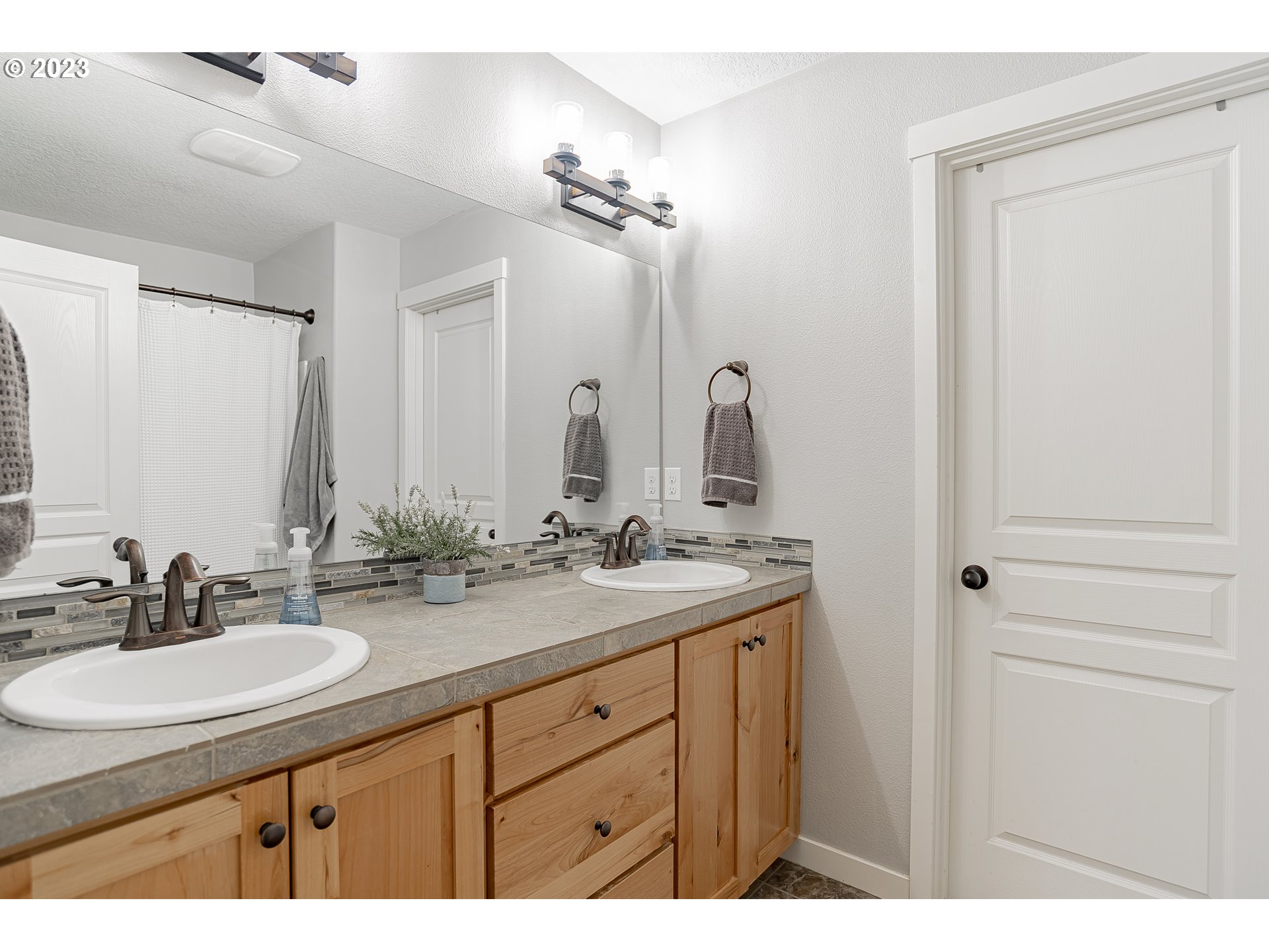 4020 North 1st Way Ridgefield, WA 98642 - Photo 24 of 32 a bathroom with a double vanity sink and a mirror