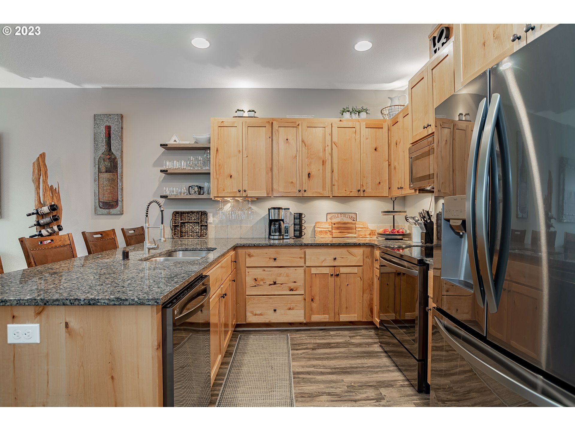 4020 North 1st Way Ridgefield, WA 98642 - Photo 5 of 32 a kitchen with stainless steel appliances granite countertop a sink refrigerator and cabinets