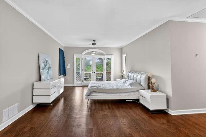 2551 East Maddox Road Buford, GA 30519 - Photo 13 of 50 a bedroom with furniture and wooden floor