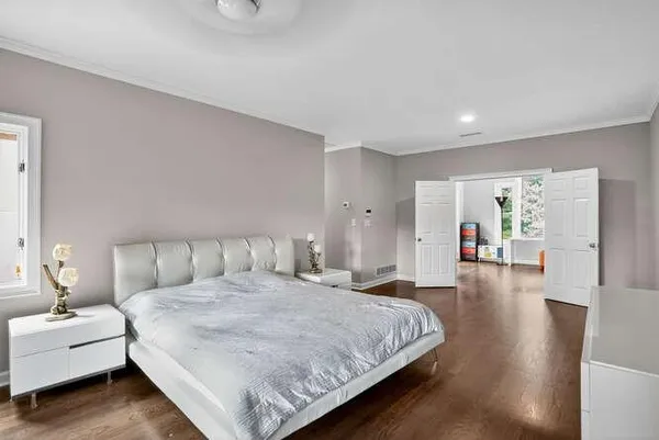 a spacious bedroom with a bed and a couch