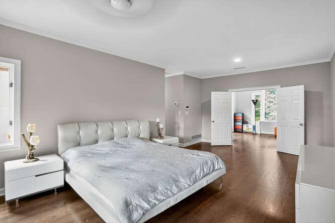 2551 East Maddox Road Buford, GA 30519 - Photo 14 of 50 a spacious bedroom with a bed and a couch