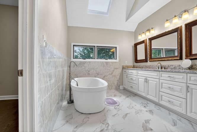 2551 East Maddox Road Buford, GA 30519 - Photo 15 of 50 a bathroom with a granite countertop toilet sink and mirror