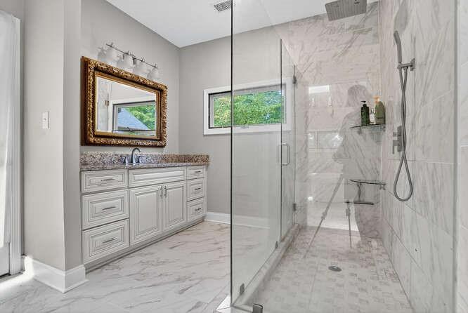 2551 East Maddox Road Buford, GA 30519 - Photo 16 of 50 a bathroom with a granite countertop sink mirror and shower