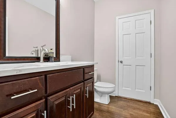 a bathroom with a sink a toilet and a mirror