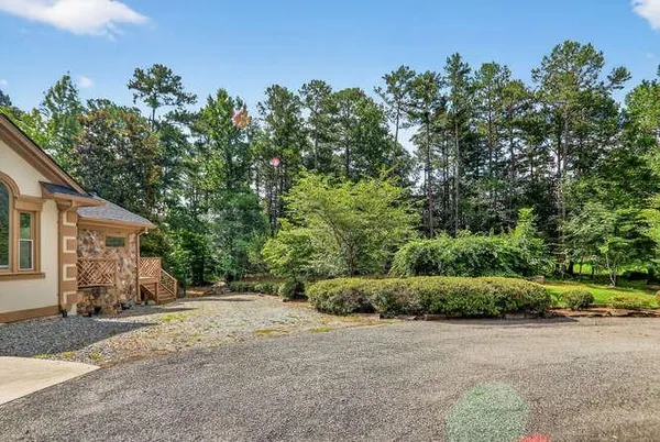 a view of a house with a yard and plant