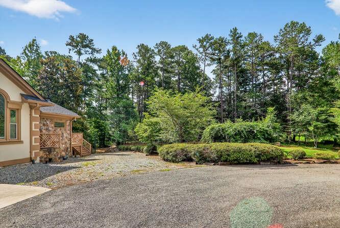2551 East Maddox Road Buford, GA 30519 - Photo 2 of 50 a view of a house with a yard and plant
