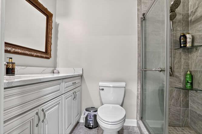 2551 East Maddox Road Buford, GA 30519 - Photo 28 of 50 a bathroom with a toilet sink vanity and granite