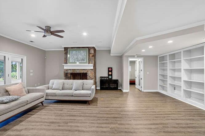 2551 East Maddox Road Buford, GA 30519 - Photo 29 of 50 a living room with furniture and a fireplace