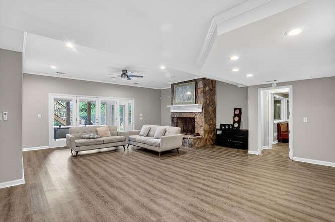 2551 East Maddox Road Buford, GA 30519 - Photo 30 of 50 a living room with furniture and a fireplace
