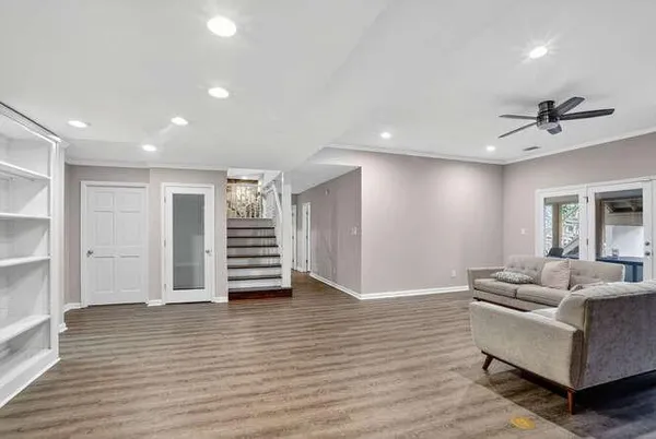 a living room with furniture and wooden floor