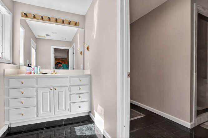 2551 East Maddox Road Buford, GA 30519 - Photo 35 of 50 a bathroom with a sink a vanity and a mirror